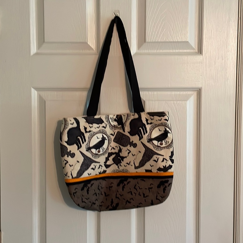Like new Halloween witch & bat tote/purse. Snap closure with 4 internal pockets